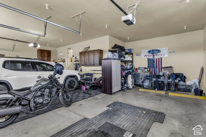 Spacious garage featuring concrete flooring and light-toned walls