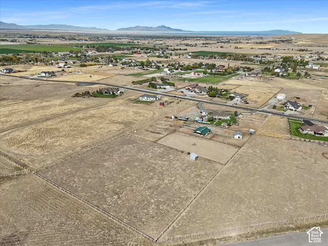 Expansive land parcel featuring clear fencing and distant mountain ranges