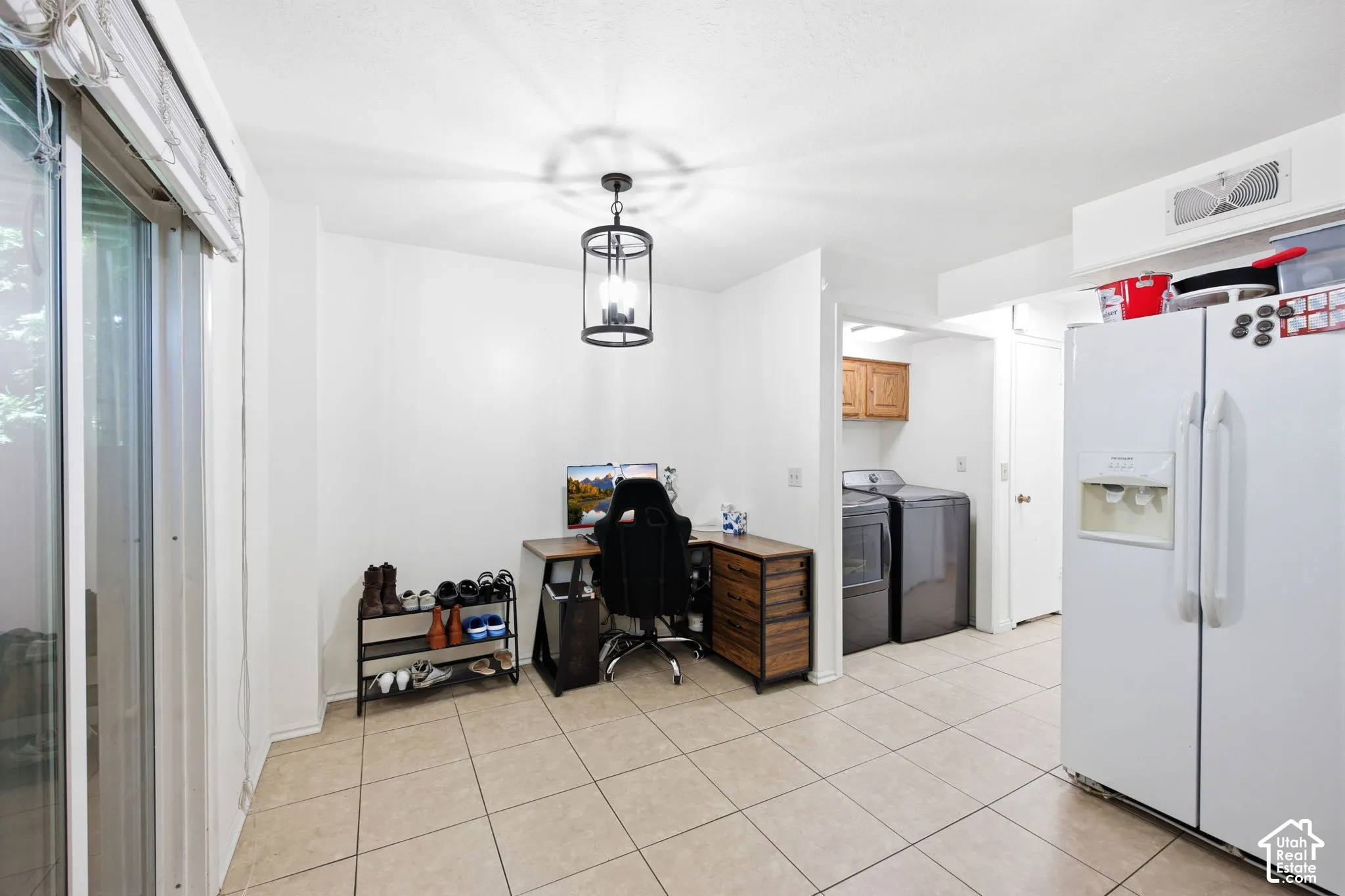Open-concept space featuring tile flooring and a glass sliding door