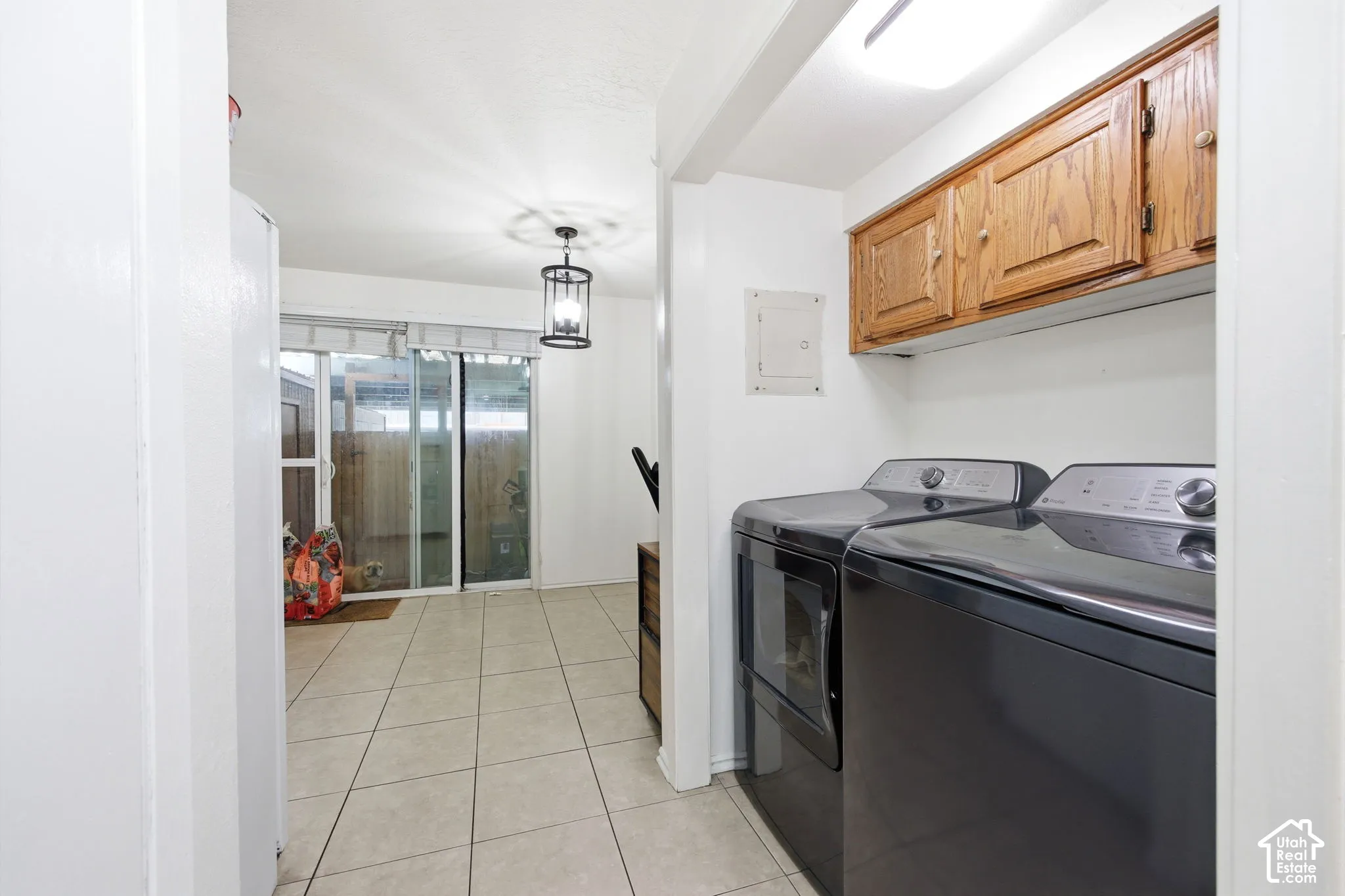 Laundry area featuring wood-finish cabinetry and built-in overhead lighting