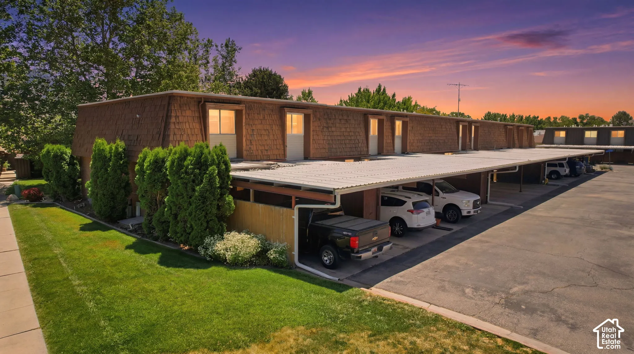 Multi-unit property featuring shake siding and a flat roofline