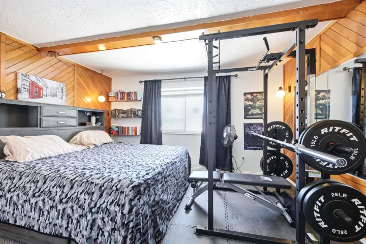 Room featuring a built-in bed frame with integrated storage and shelving