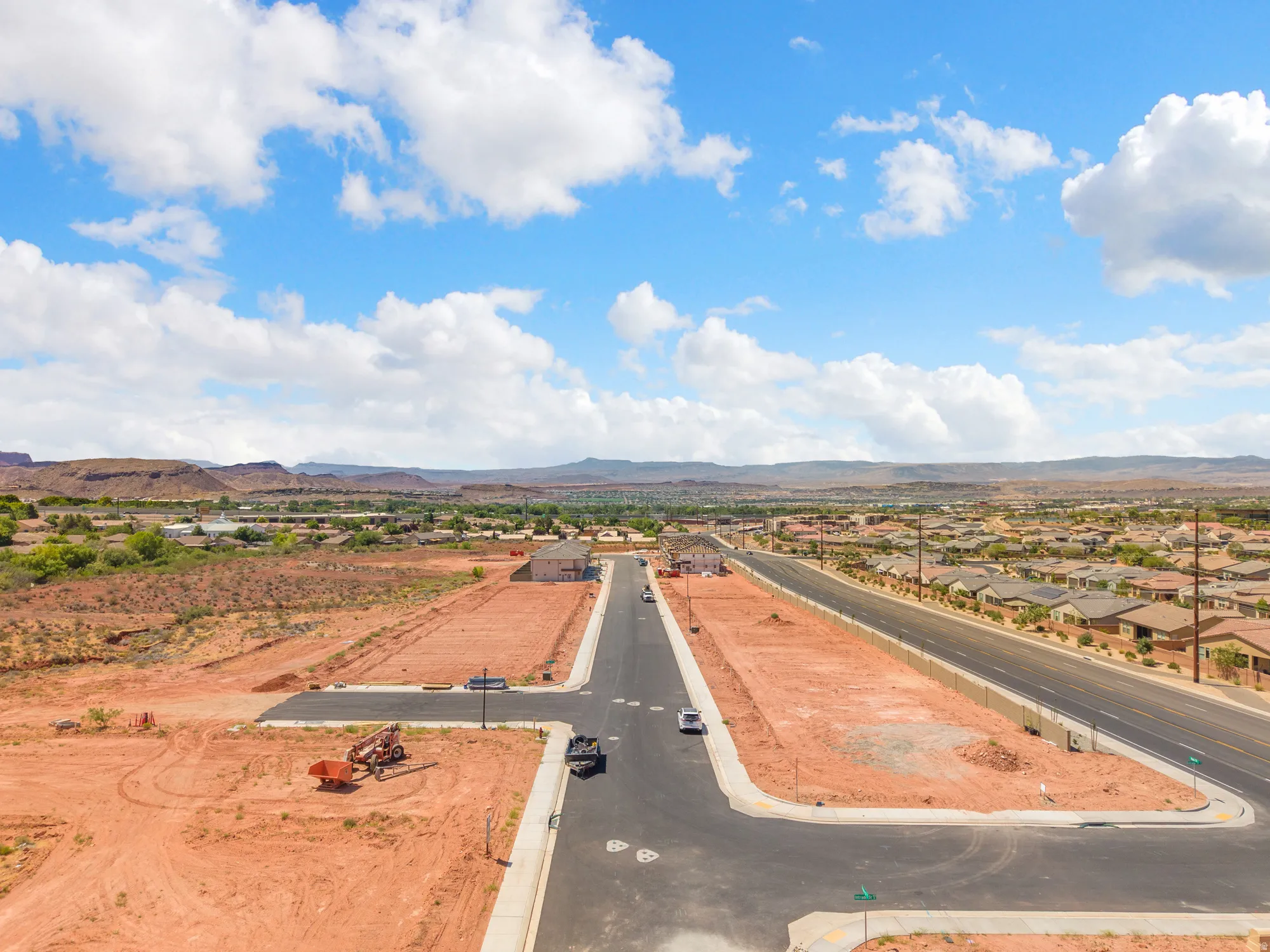 Expansive land parcels featuring established infrastructure including paved roads and sidewalks
