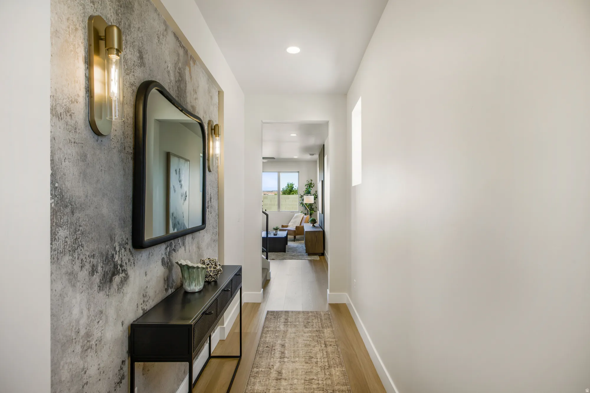 Entryway hall featuring a textured accent wall, wood-finish flooring, and recessed lighting