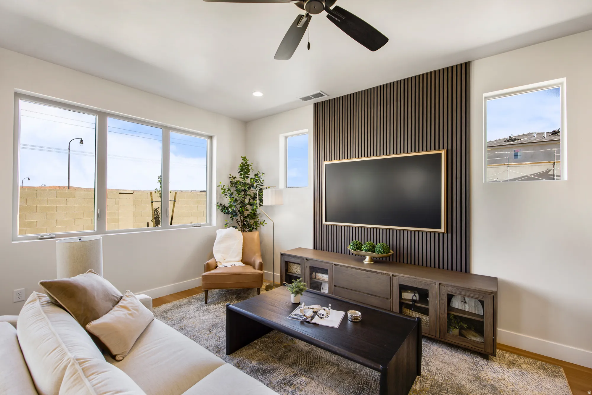 Living area featuring a slatted accent wall with integrated media console