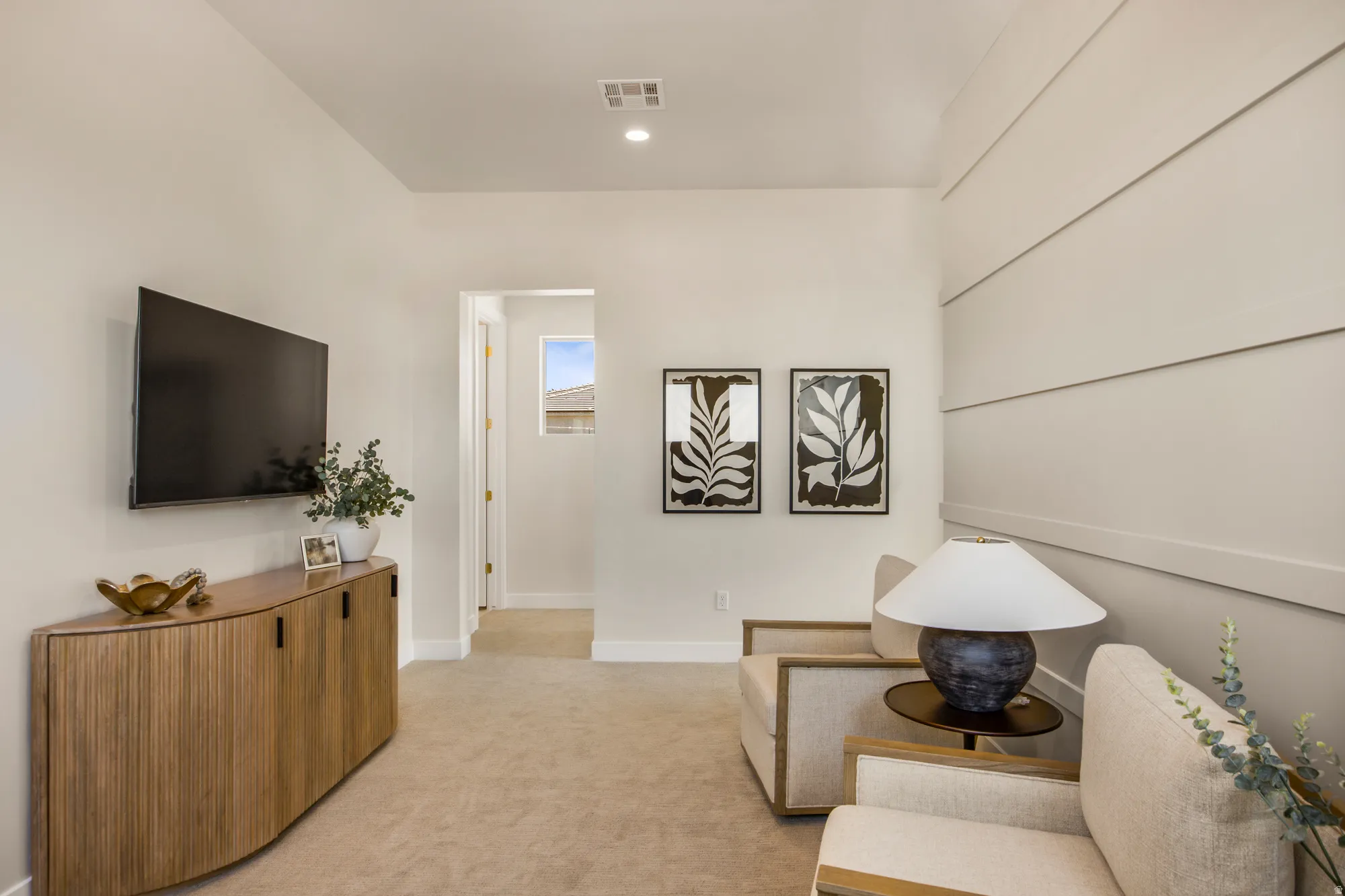 Carpeted room featuring a white shiplap accent wall, recessed ceiling lighting, and light-toned wall paint