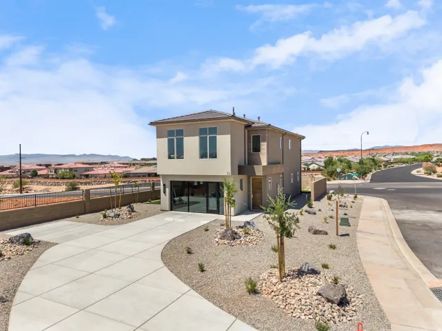 Contemporary two-story residence featuring a flat roofline and stucco exterior