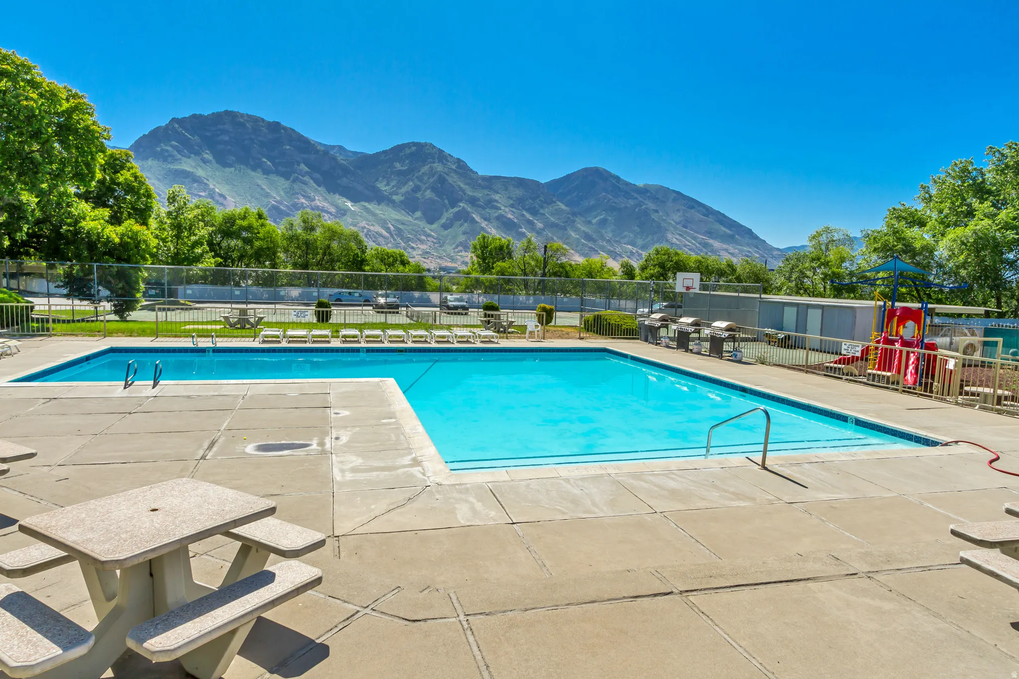 Expansive outdoor swimming pool with surrounding concrete decking