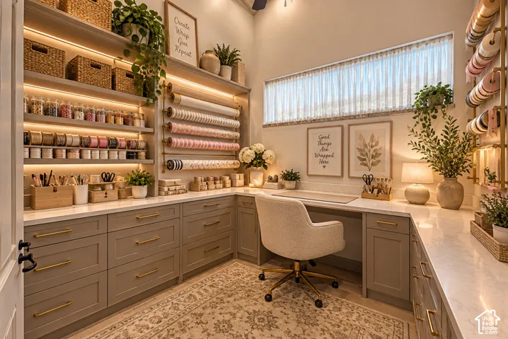 Built-in cabinetry with ample storage, integrated task lighting, a dedicated desk area, and a large horizontal window