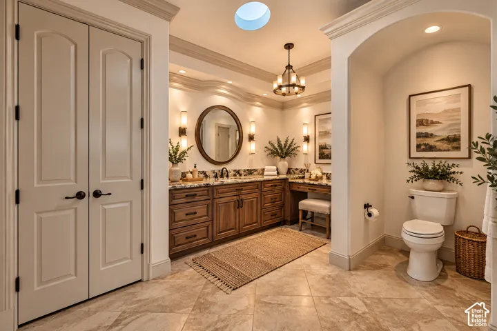 Dual vanities with stone countertops, wood-finish cabinetry, and sconce lighting