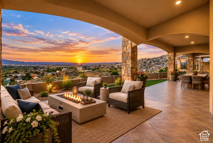 Expansive outdoor living area with a stone-clad archway, tiled flooring, and a built-in fire pit
