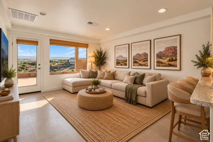 Recessed ceiling lighting, tiled flooring, built-in breakfast bar with stone countertop, and outdoor patio access