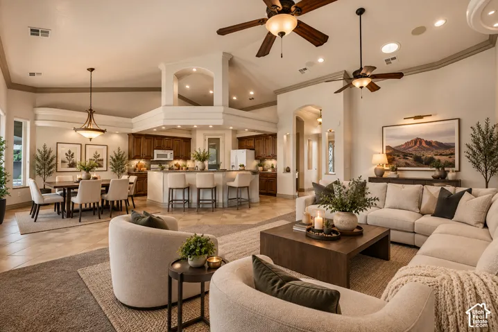 Open-concept living space with vaulted ceilings, recessed lighting, ceiling fans, and tiled flooring