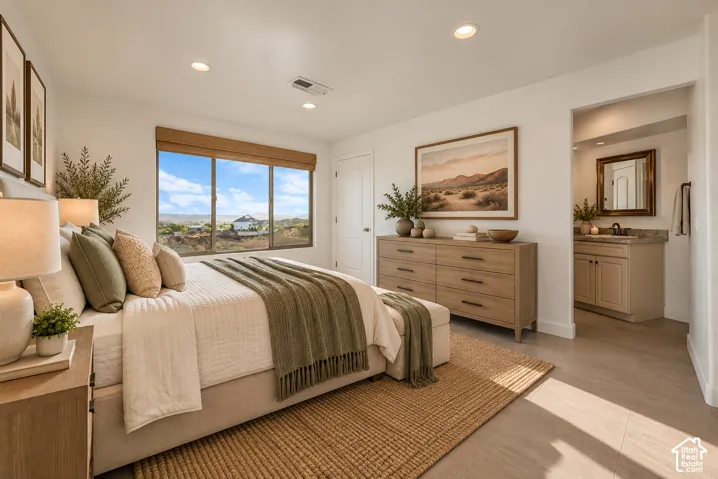 Recessed lighting, large window with natural scenery, light wood-finish flooring, and a vanity with a sink and mirror