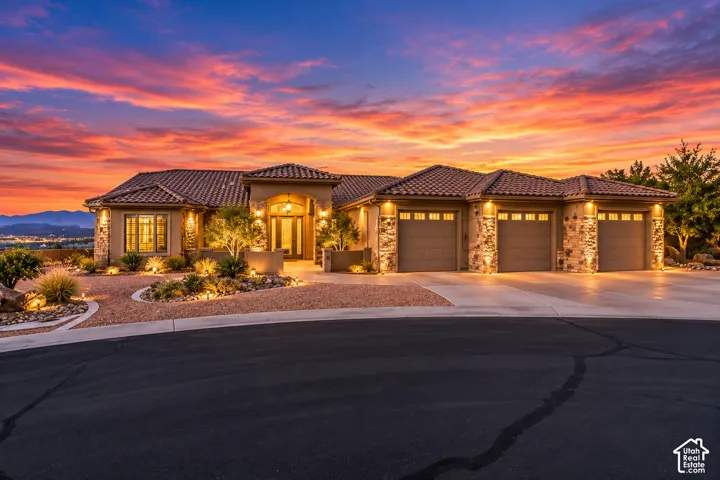 Mediterranean-style architecture with a tile roof, stone accents, and a stucco exterior