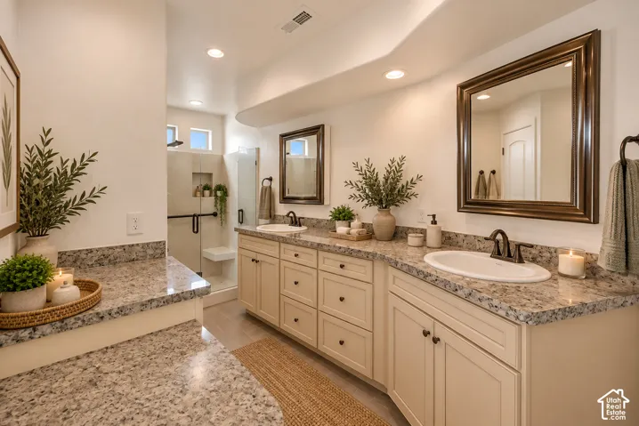 Dual vanity with granite countertops, undermount sinks, and dark bronze fixtures