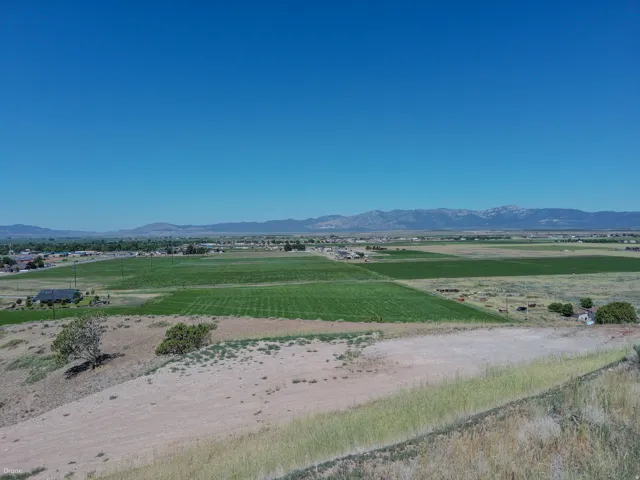 Expansive open terrain featuring natural grasses and scattered shrubbery