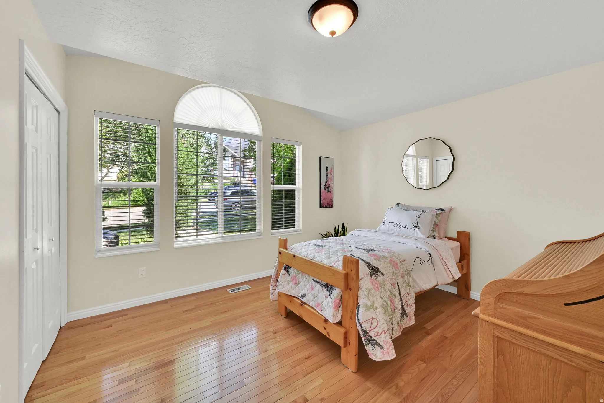 Windowed room with light wood-finish flooring