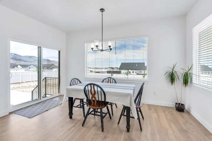 Dining area featuring wood-finish flooring and white walls