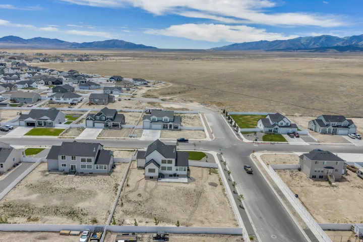 New construction neighborhood featuring a variety of single-family homes, paved streets, and a mountainous backdrop