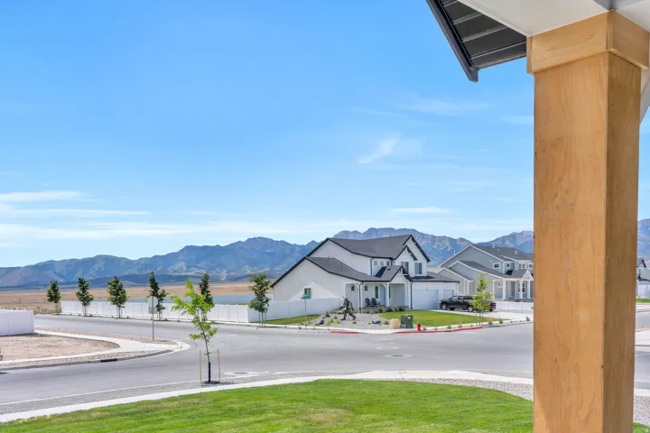 Modern architecture with a light-toned stucco exterior and a dark gabled roof