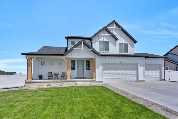 Modern farmhouse-style exterior featuring white board-and-batten siding with dark trim accents