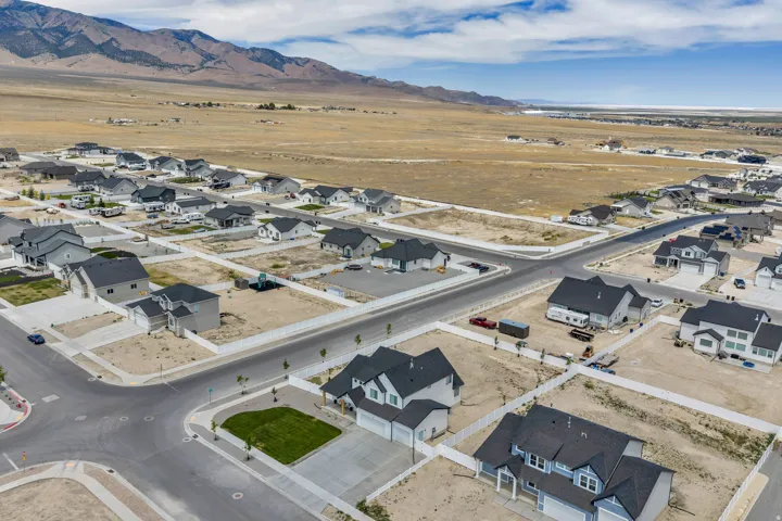 Aerial view of a new residential development featuring multiple single-family homes and vacant lots