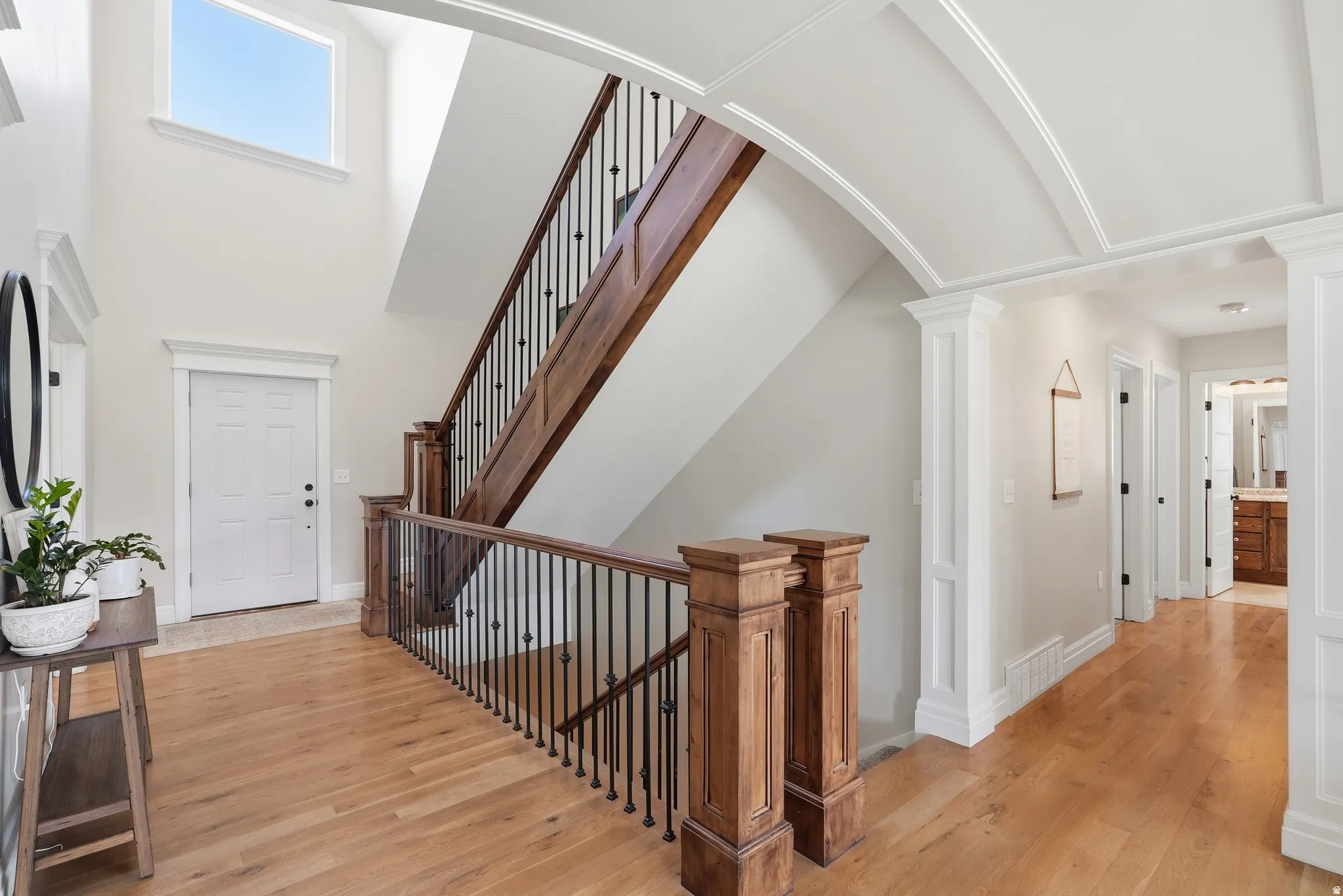 Grand entryway with a two-story ceiling and a large transom window