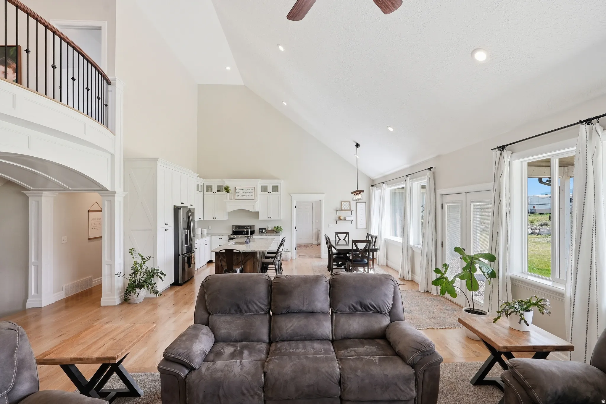 Open-concept living space featuring vaulted ceilings and recessed lighting