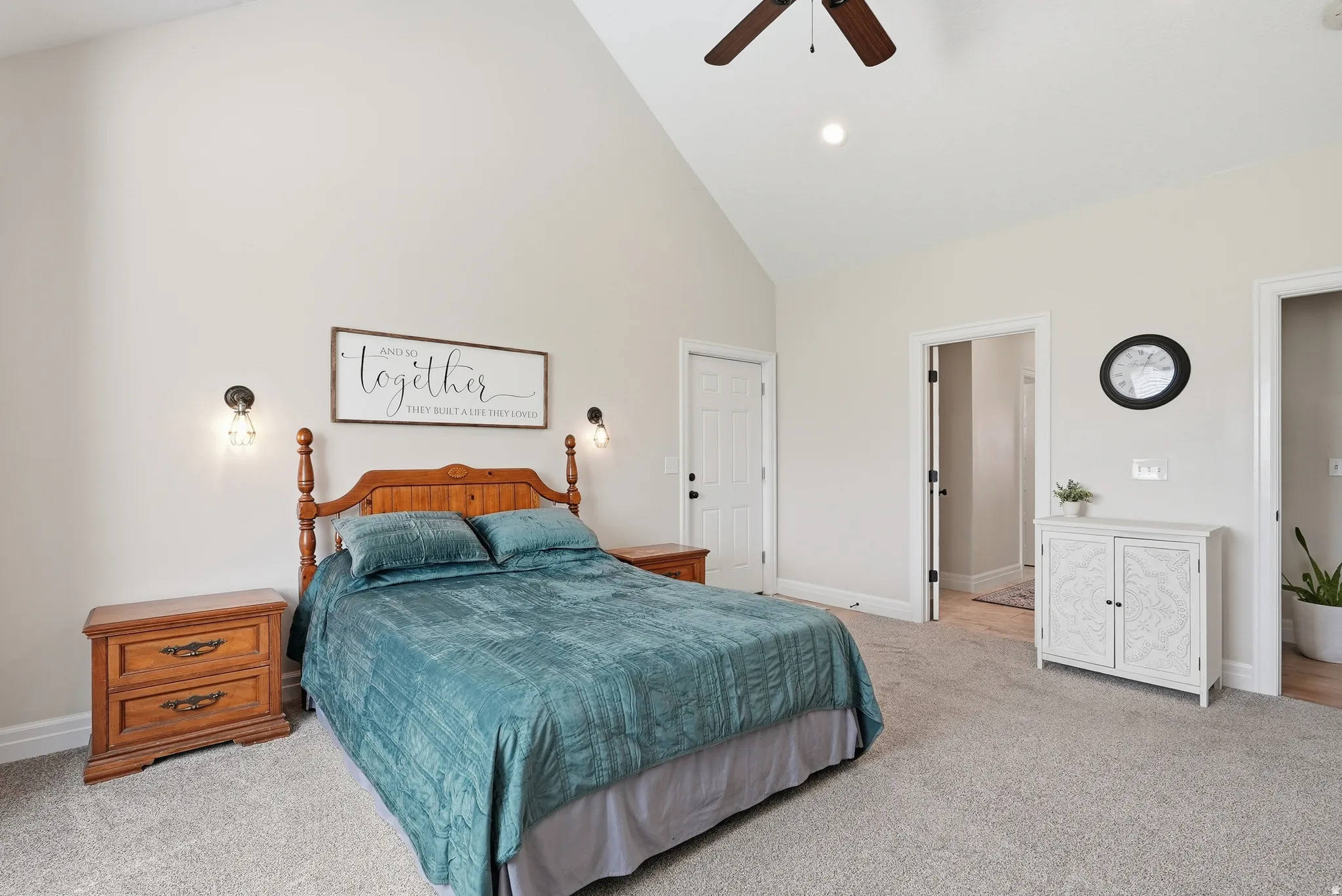 Bedroom featuring a vaulted ceiling with a ceiling fan, recessed lighting, and wall-mounted sconces