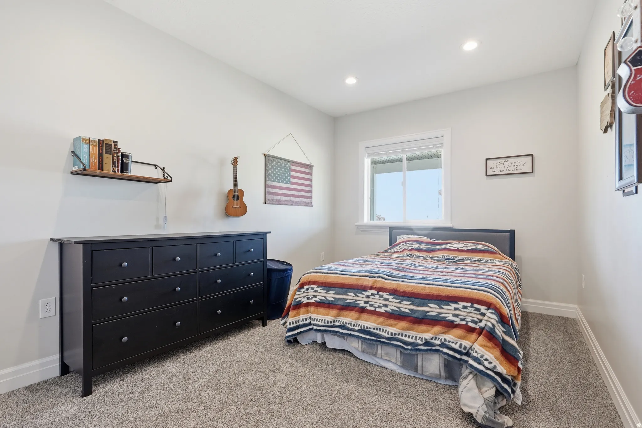 Carpeted room featuring a white-framed window, recessed lighting, and light-toned walls