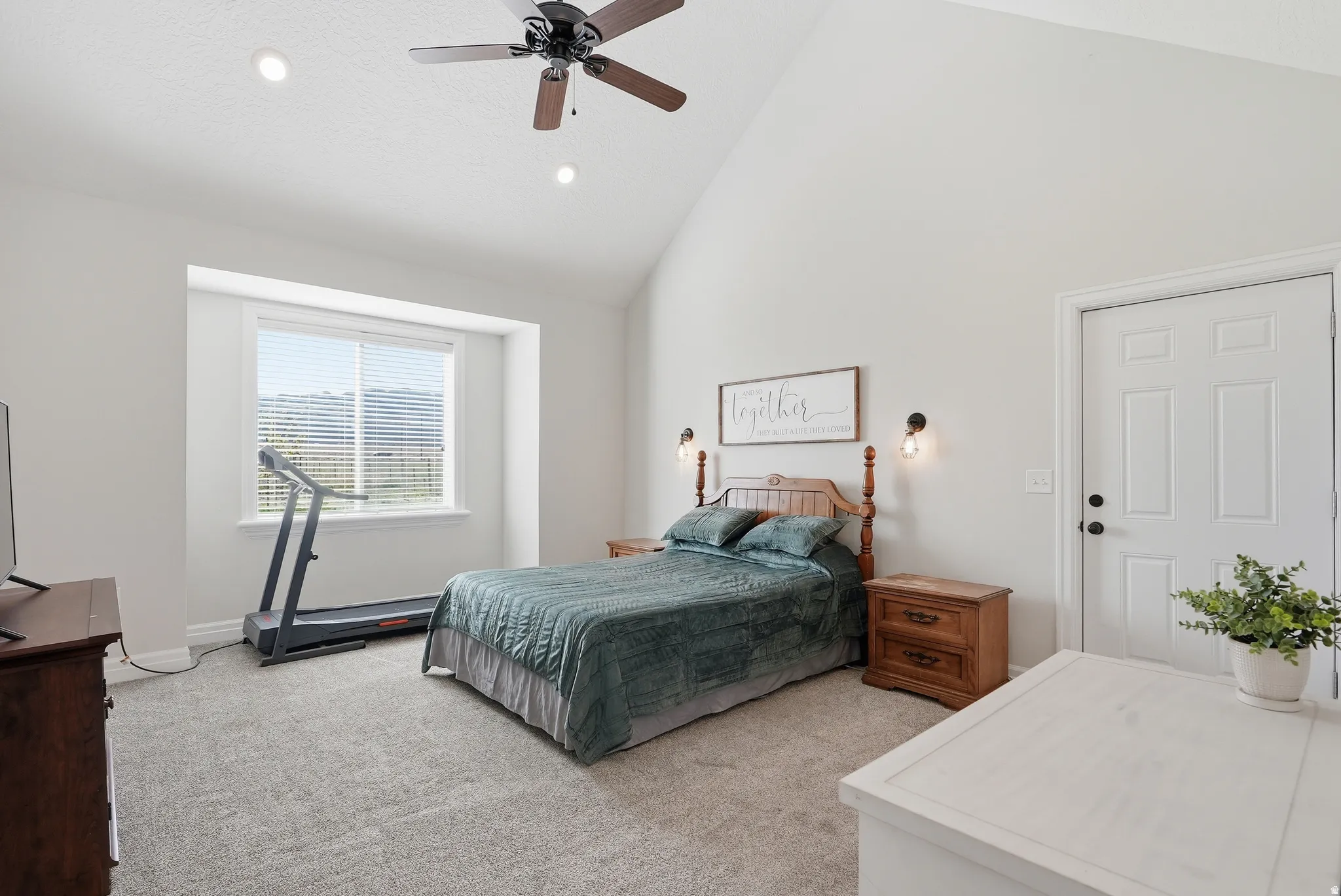 Vaulted ceiling room featuring recessed lighting, a ceiling fan, plush carpet, and a large window with blinds