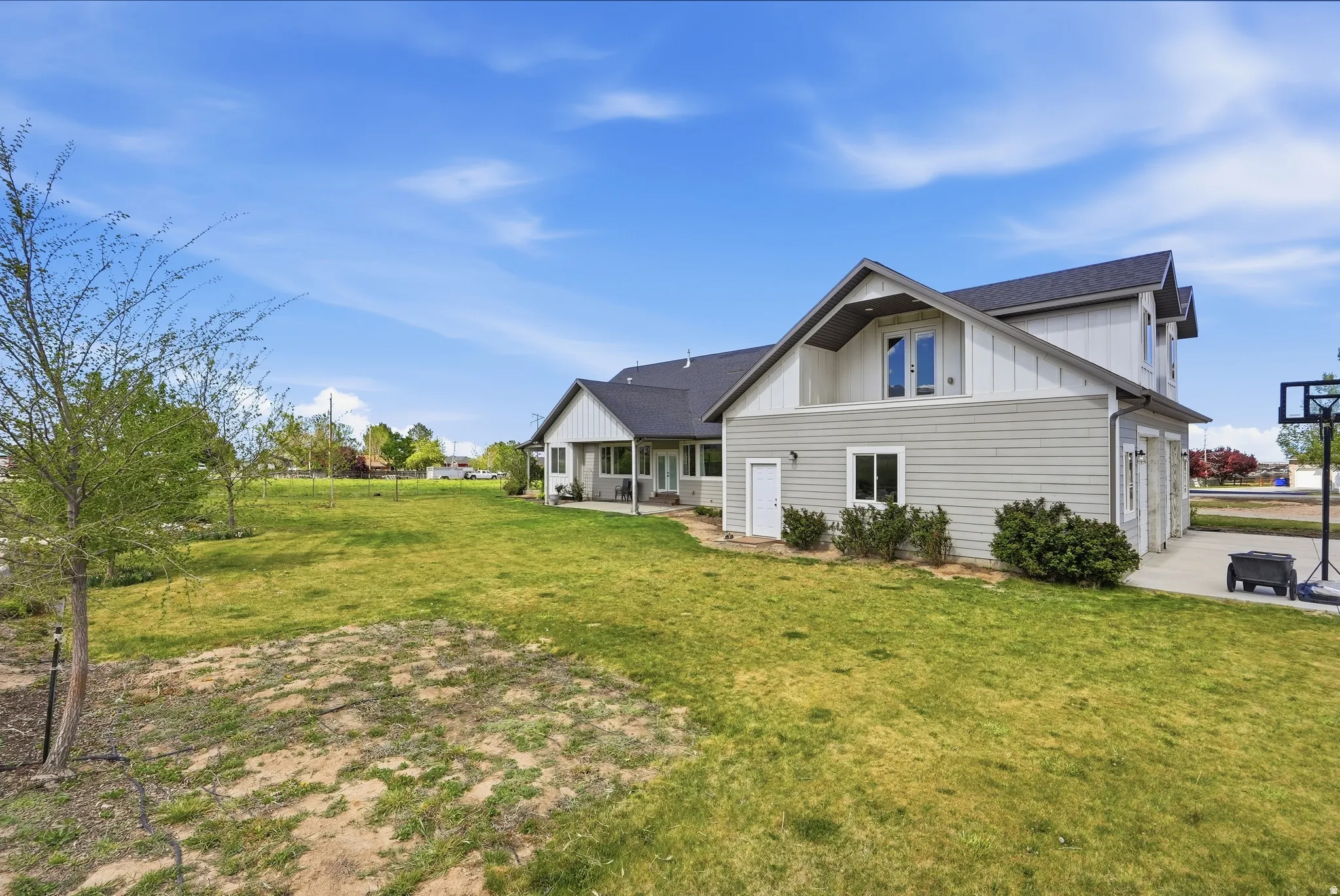 Expansive side yard with a substantial green lawn