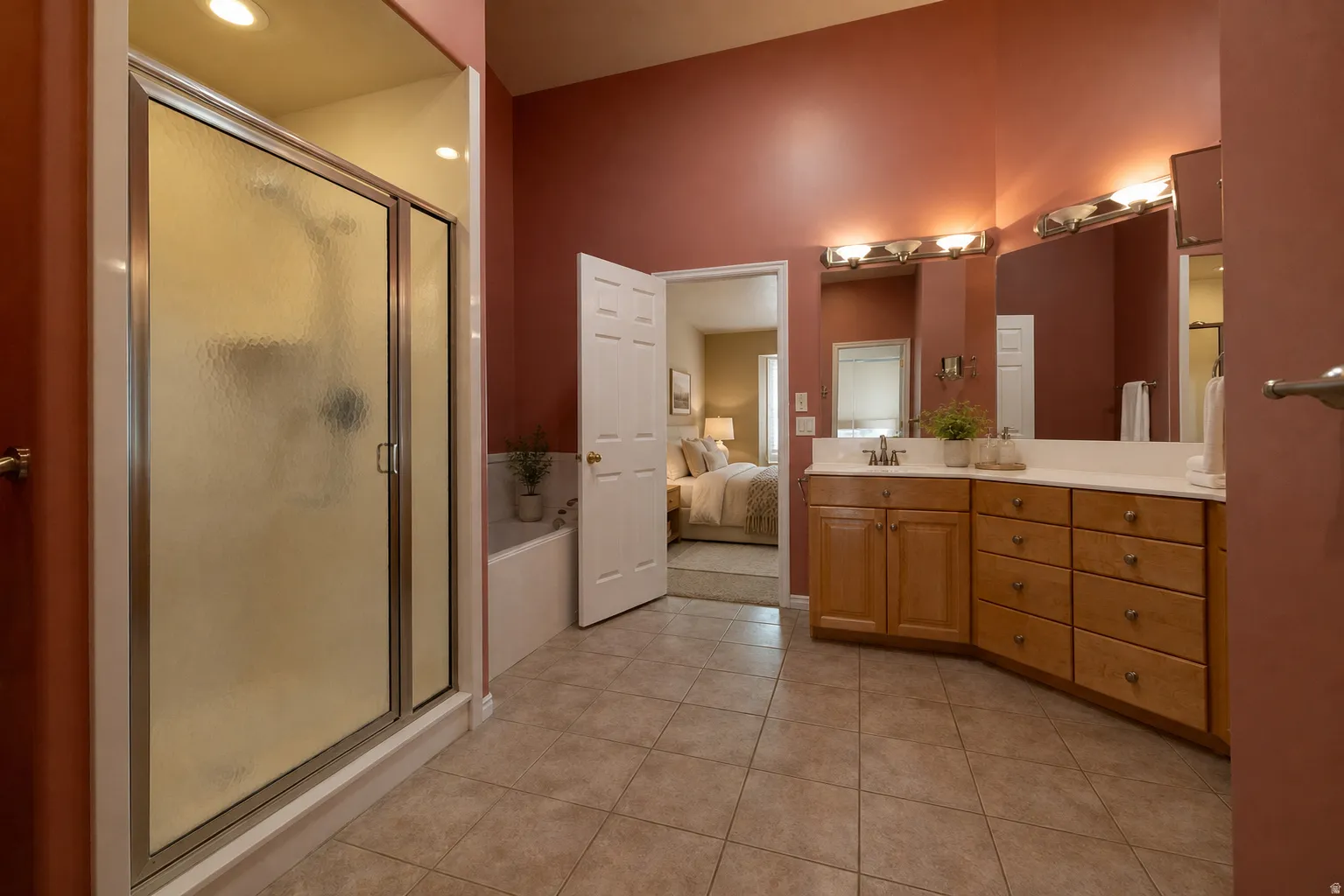 Virtually Staged - Master bathroom featuring a large frosted glass shower enclosure, a separate built-in jetted bathtub, and an expansive vanity with double mirrors