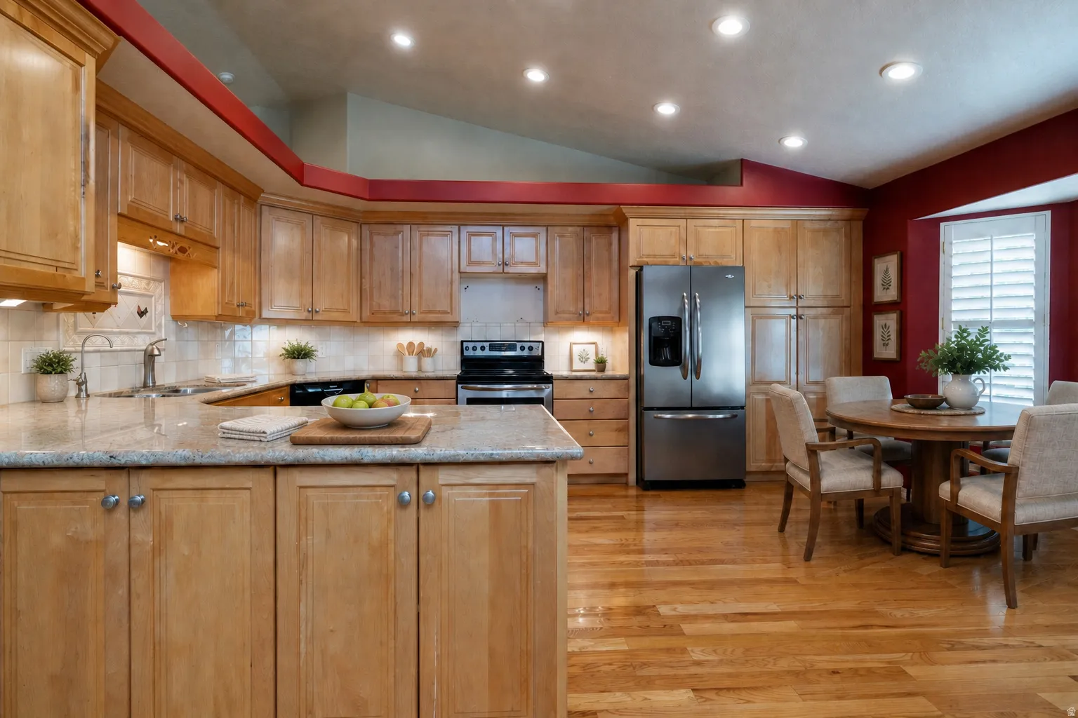 Virtually Staged - Kitchen featuring light wood cabinetry and countertops, integrated stainless steel appliances, recessed lighting, and wood-finish flooring