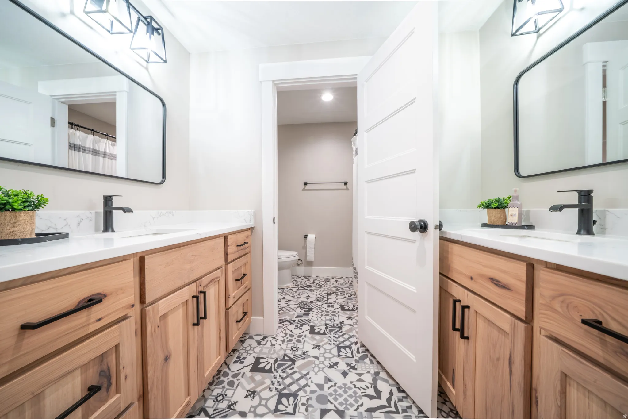 Basement full Bathroom. Two separate vanities, with private shower and toilet room.