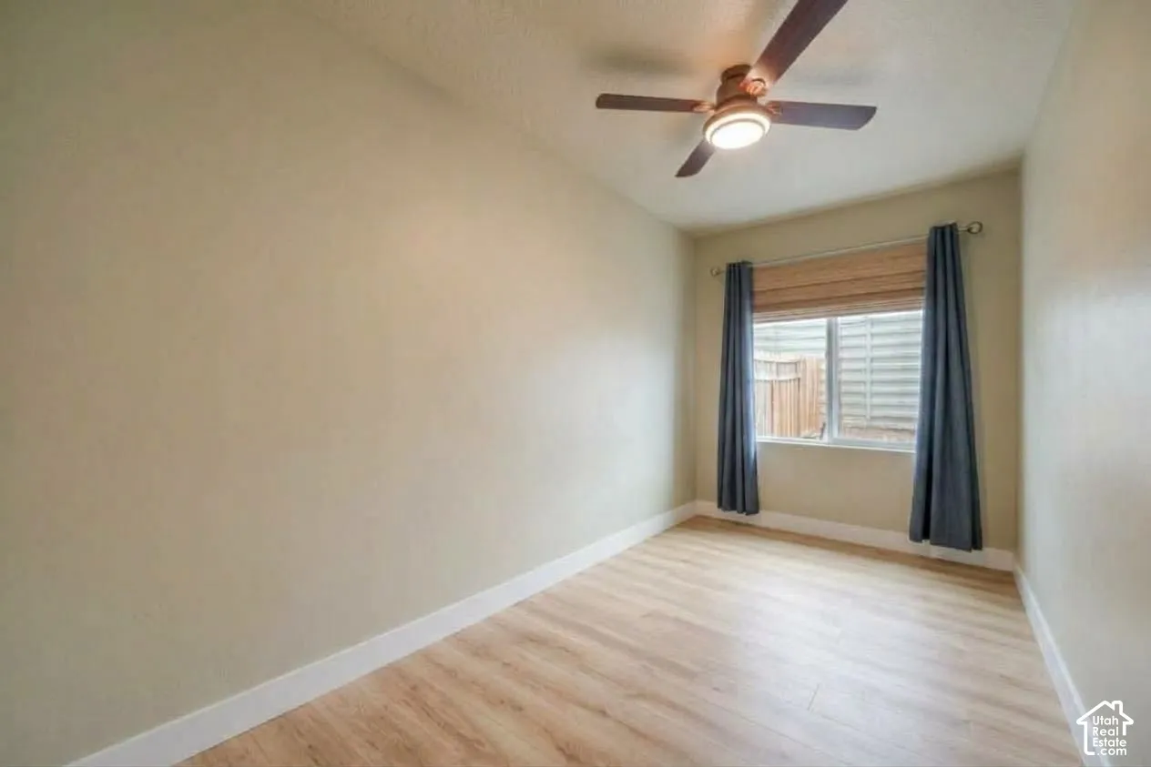 Wood-finish flooring, recessed window, and ceiling fan with integrated lighting