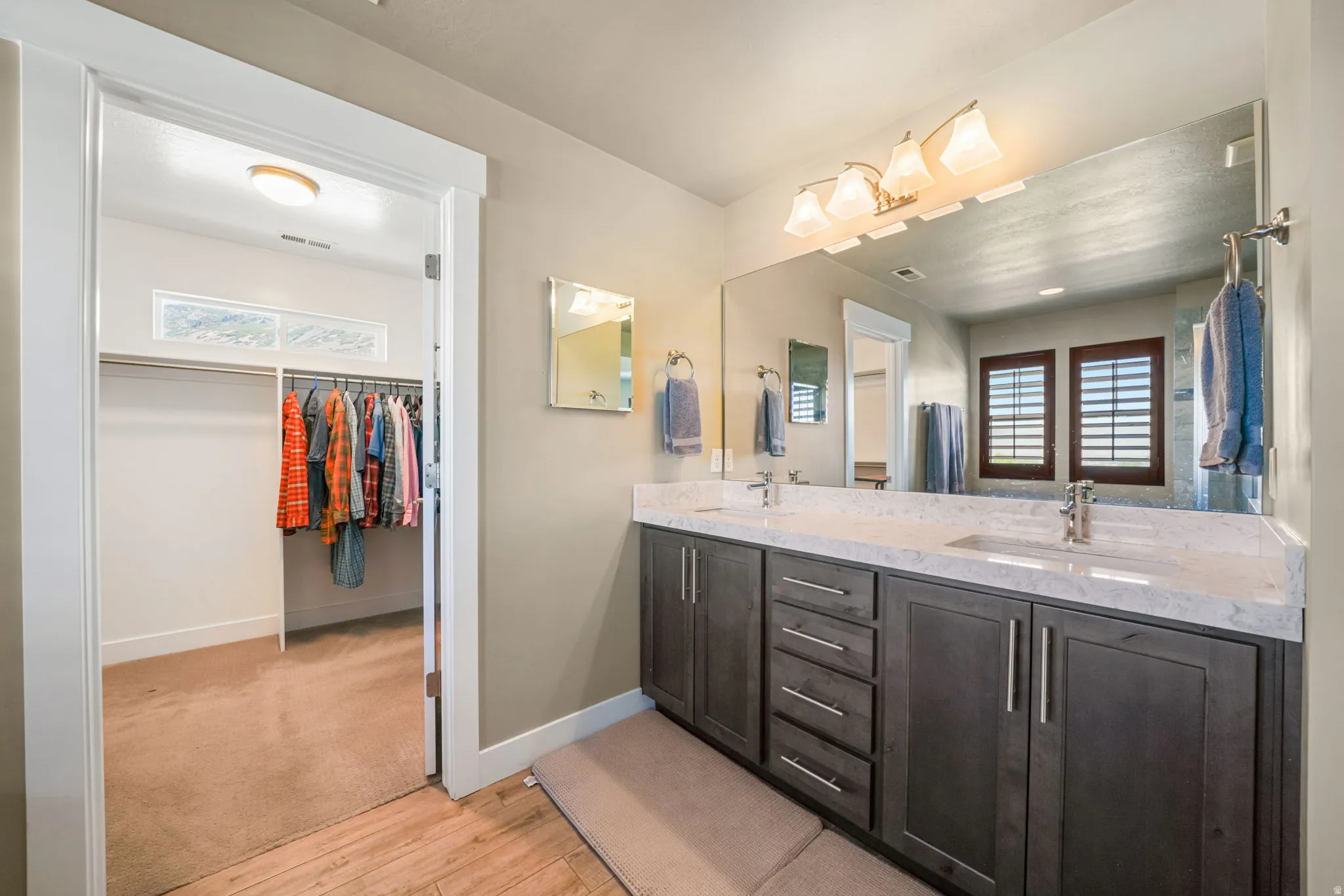 Dual vanity with a light-colored countertop and integrated sinks