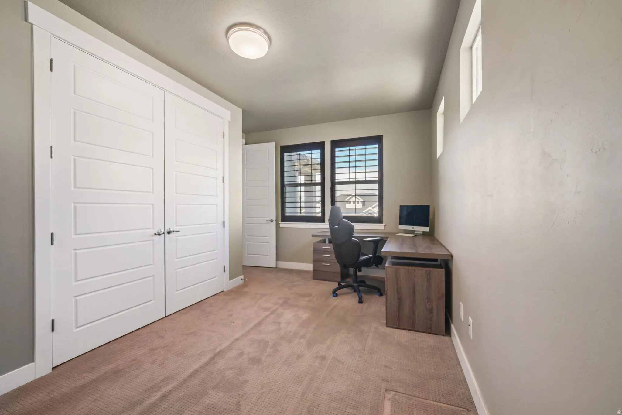 Room featuring twin panel closet doors with brushed nickel hardware