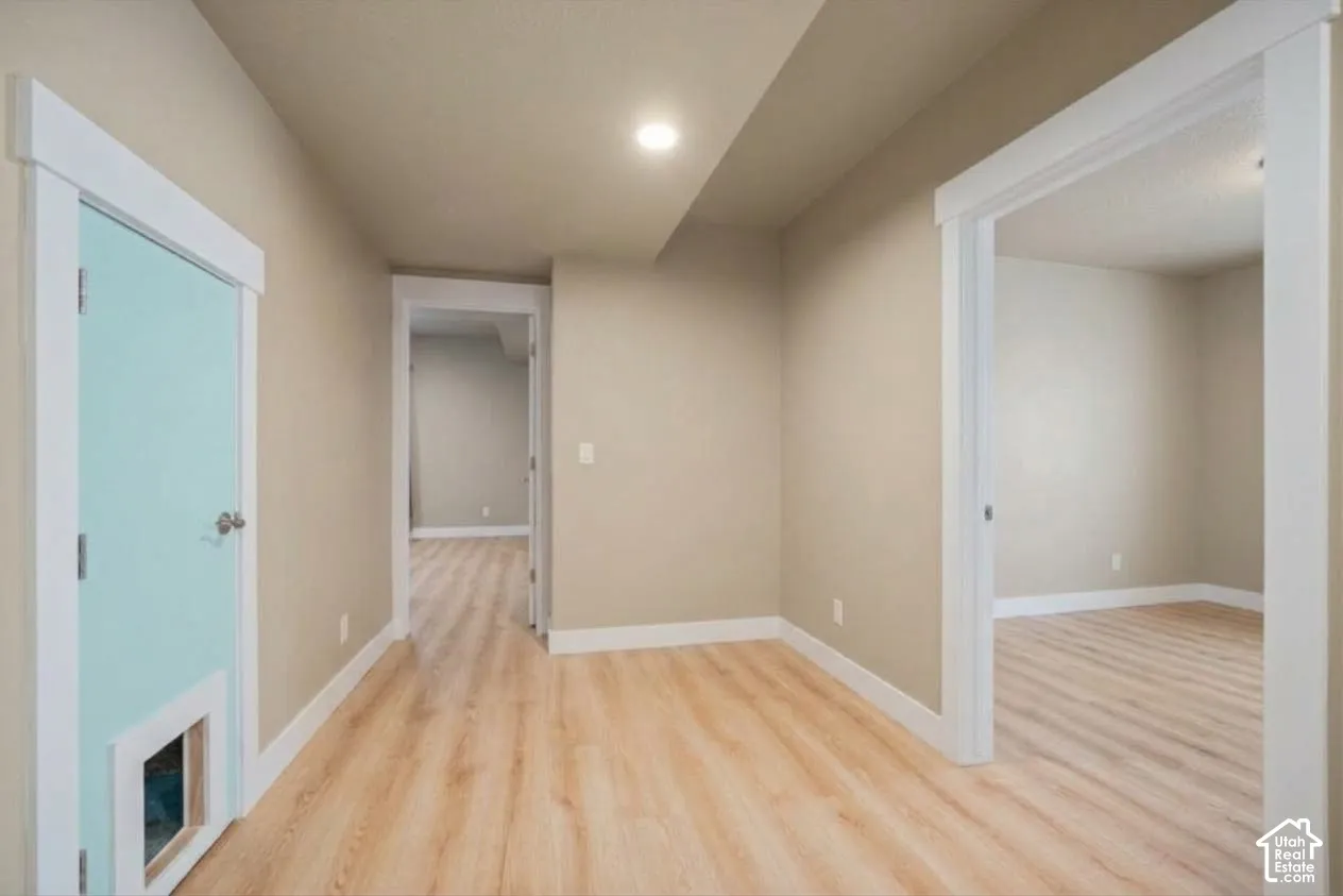 Wood-finish flooring throughout, recessed ceiling lighting, and light-toned wall finishes