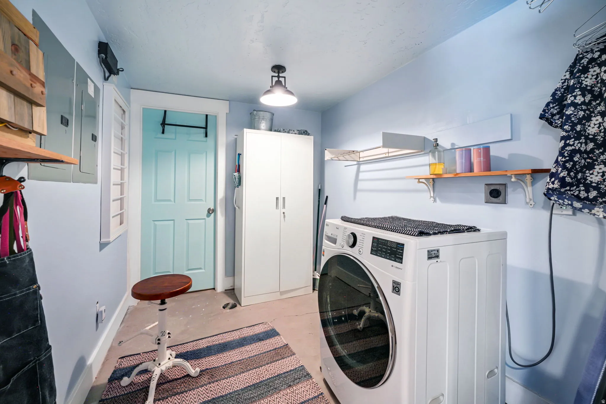 Utility space featuring light blue walls and a light-colored floor