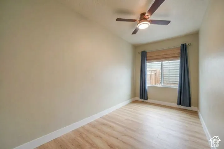 Wood-finish flooring, recessed window, and ceiling fan with integrated lighting