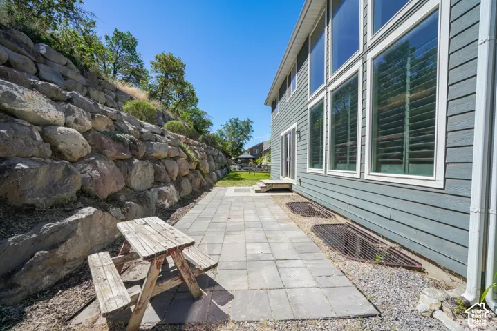 Exterior stone retaining wall and a paver patio space