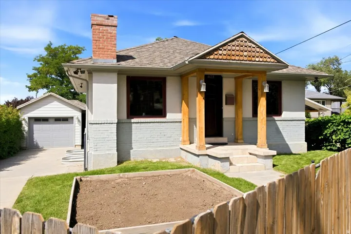 Craftsman-style exterior with wood-clad porch columns and detailed shingle siding accent