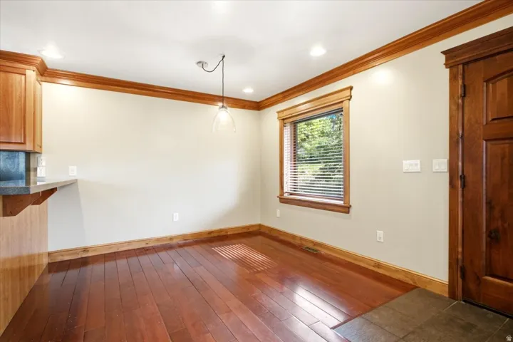Hardwood-finish flooring and light-toned walls with wood trim