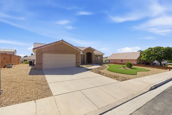 Southwestern-style residence featuring a stucco exterior and a tiled roof