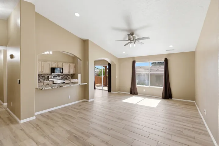 Expansive living area featuring wood-finish flooring and vaulted ceilings