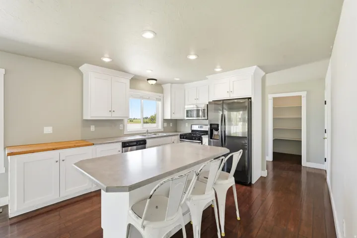 Kitchen featuring white cabinetry, dark wood-finish flooring, and recessed lighting