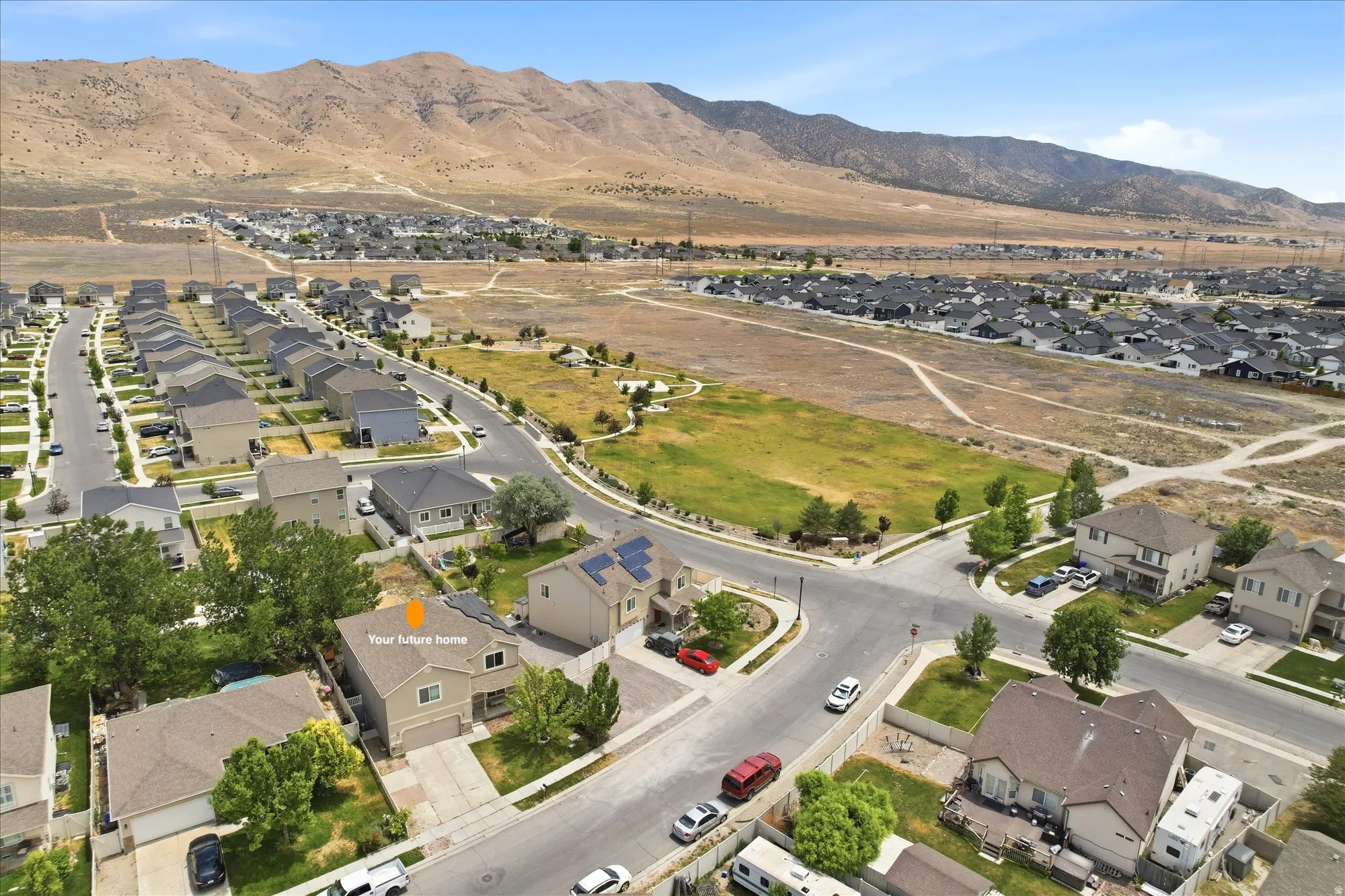 Aerial perspective showcasing a residential neighborhood with distant mountain scenery