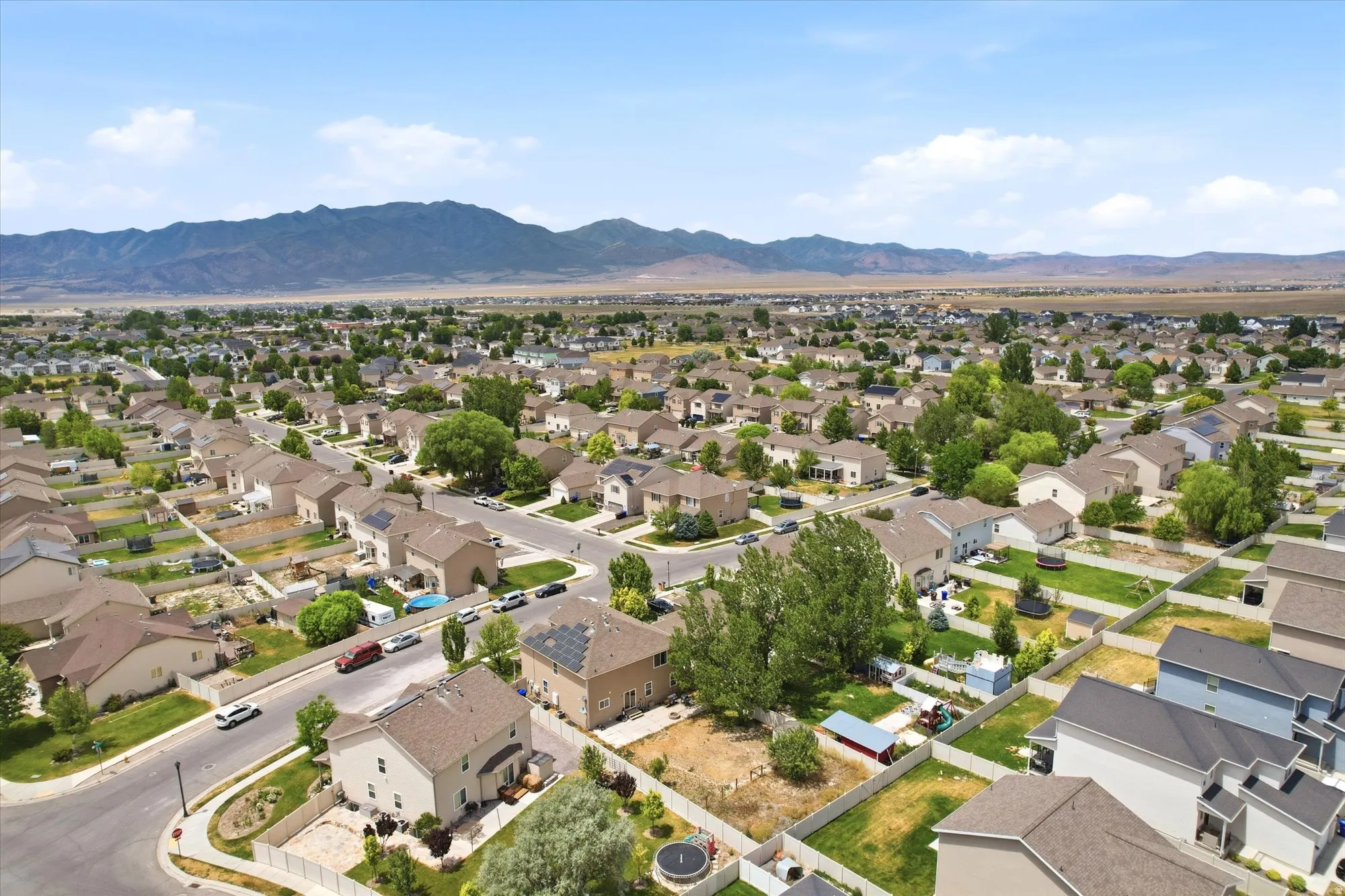Expansive residential neighborhood featuring single-family homes with pitched roofs and fenced backyards